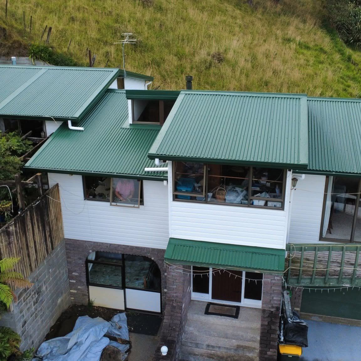 Completed long-run corrugate iron re-roof in green Coloursteel