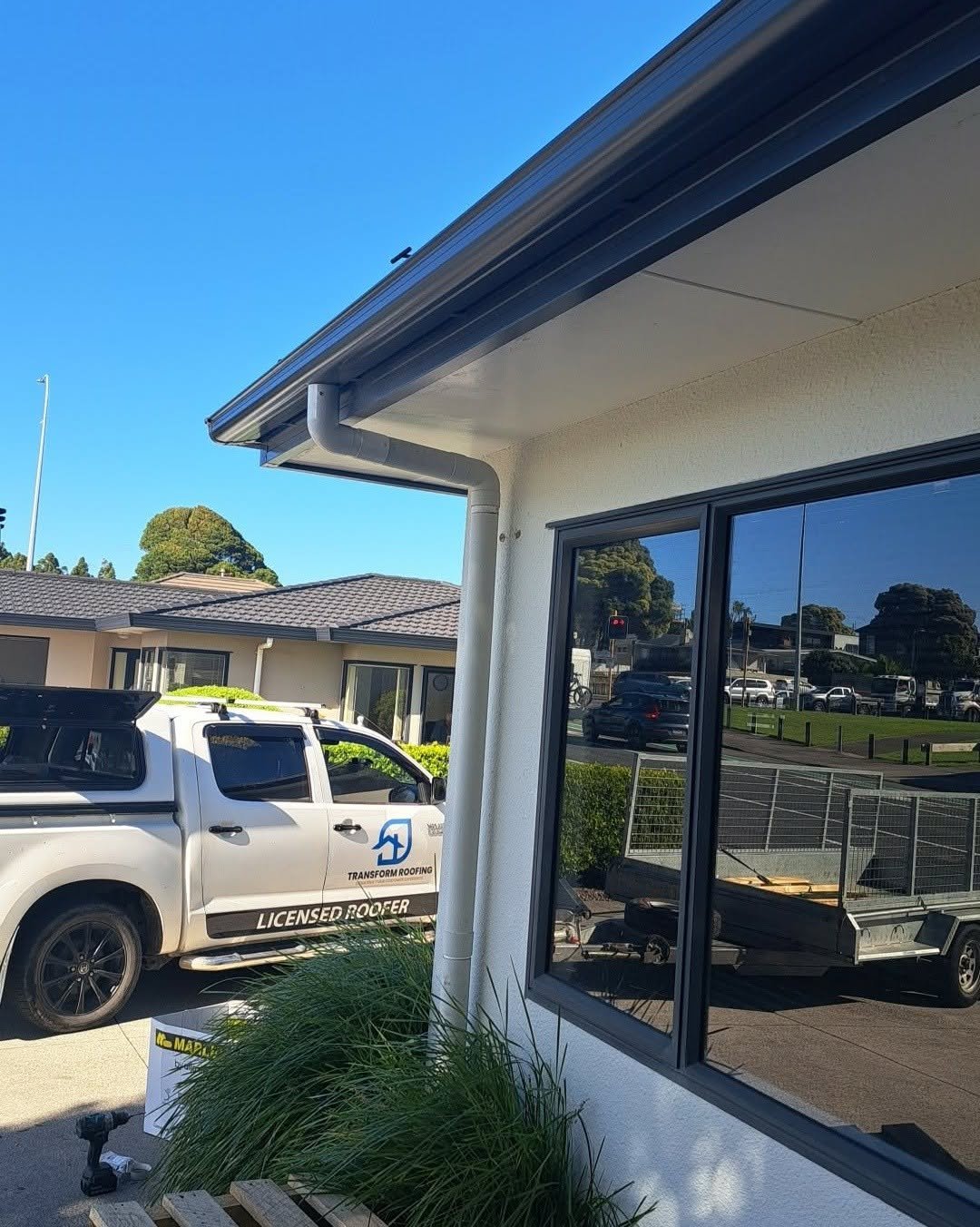 New external fascia and spouting system installed with clean downpipe, Transform Roofing ute on site