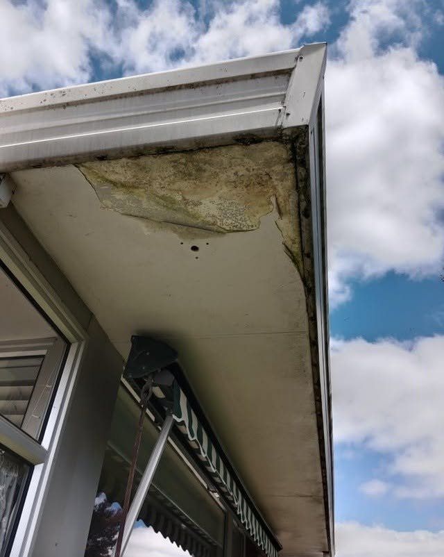 Water-damaged soffit and failing internal spouting before conversion
