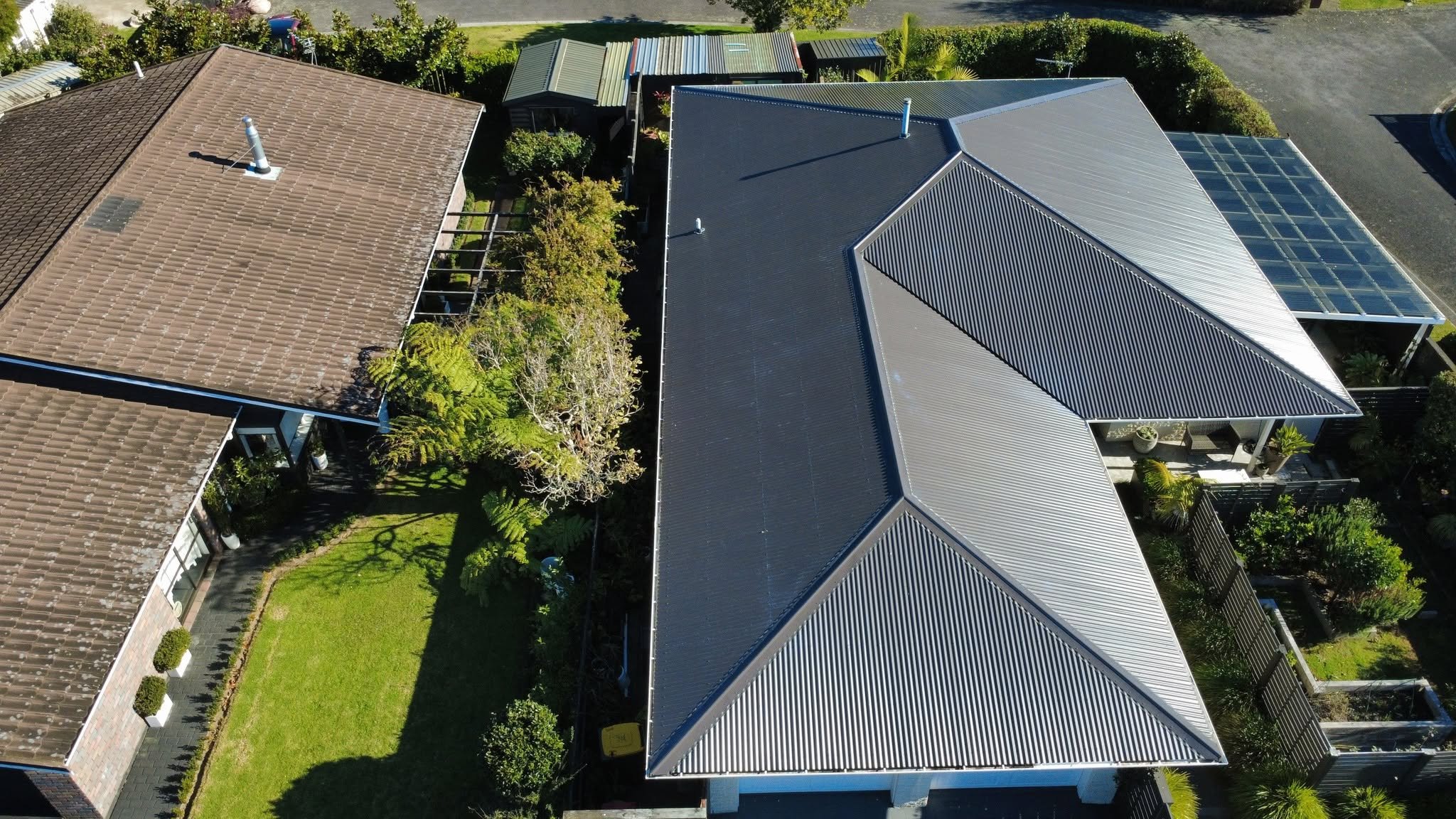 Completed tile to iron conversion with new dark grey corrugate roof, New Plymouth