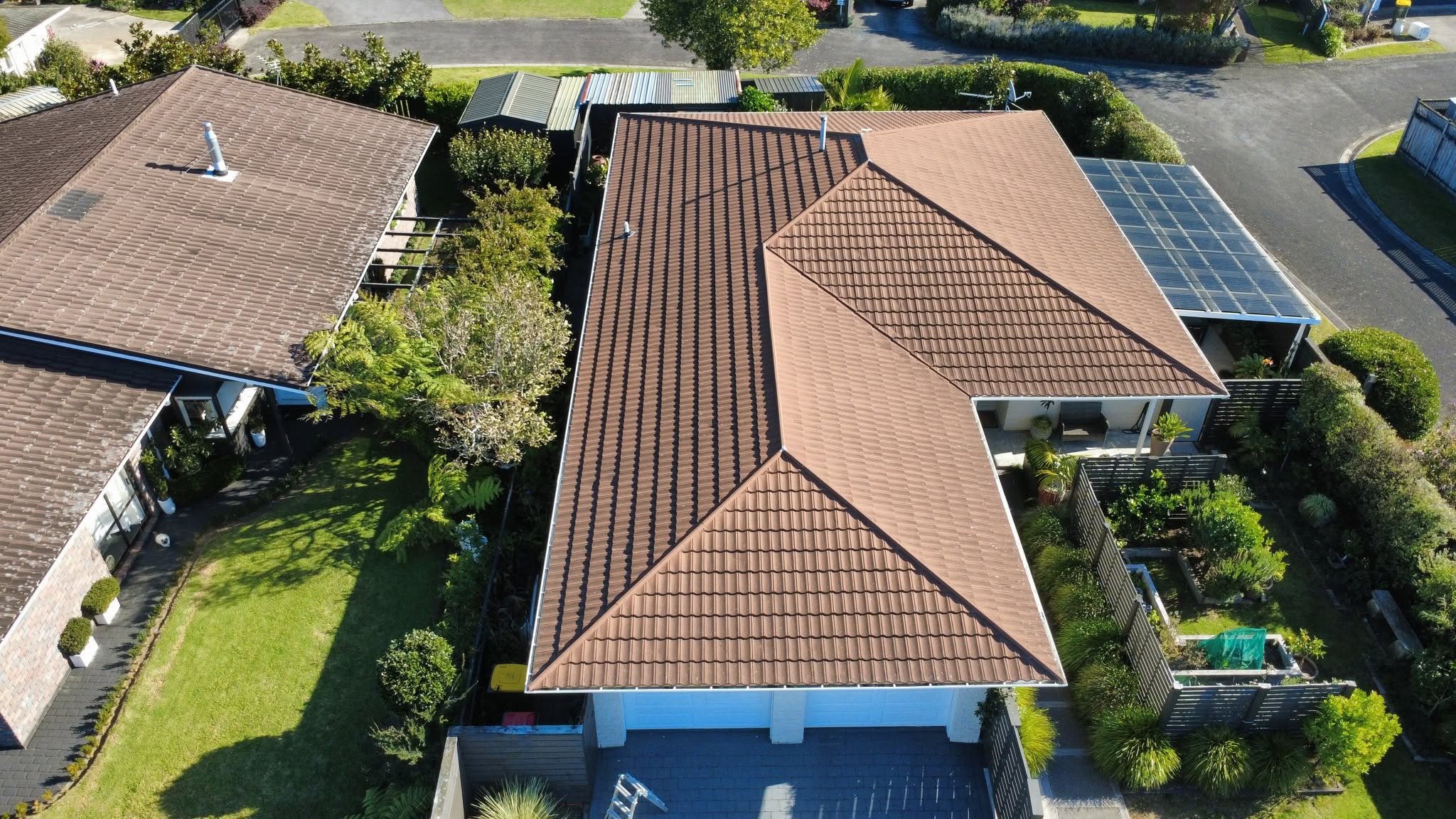 Aged brown concrete tile roof before conversion to metal